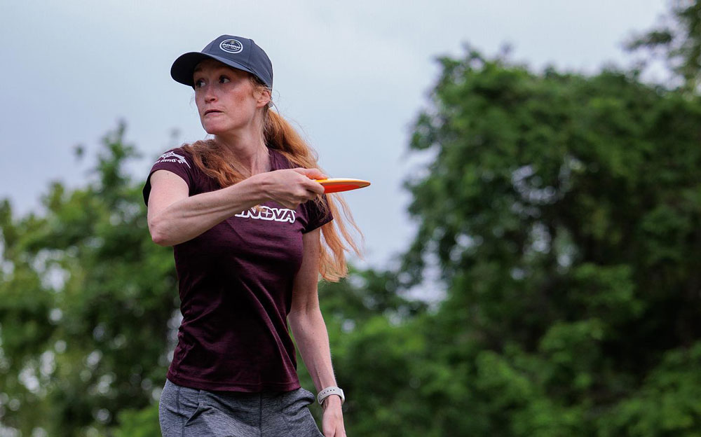 Holly Finley, disc in hand, getting ready to release a throw.
