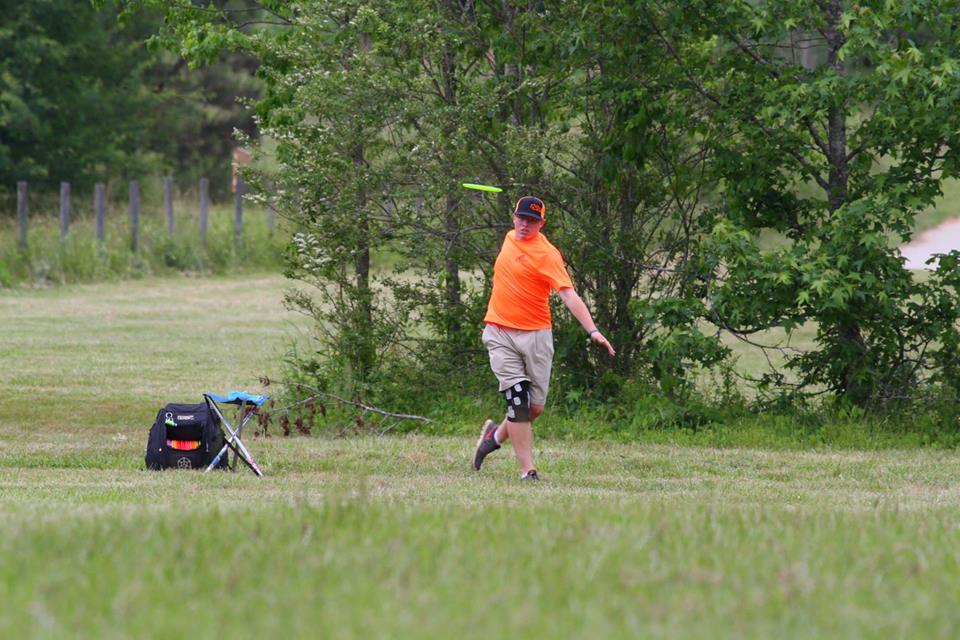 Philip-Tyler Belt releasing a disc with a black GRIPeq bag and a stool next to him.