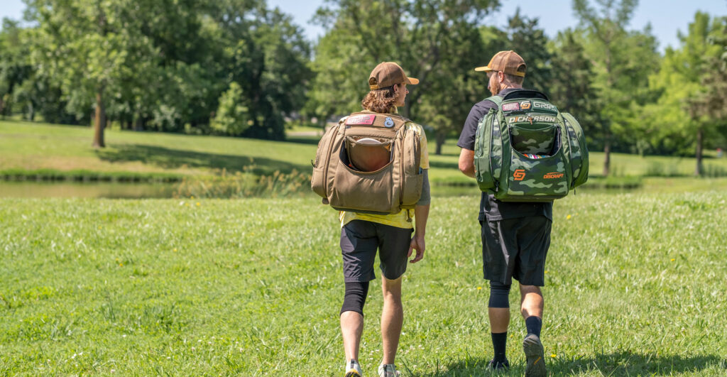 Chris Dickerson and Ben Callaway walk away from the camera talking to each other with their GRIPeq bags on their backs.