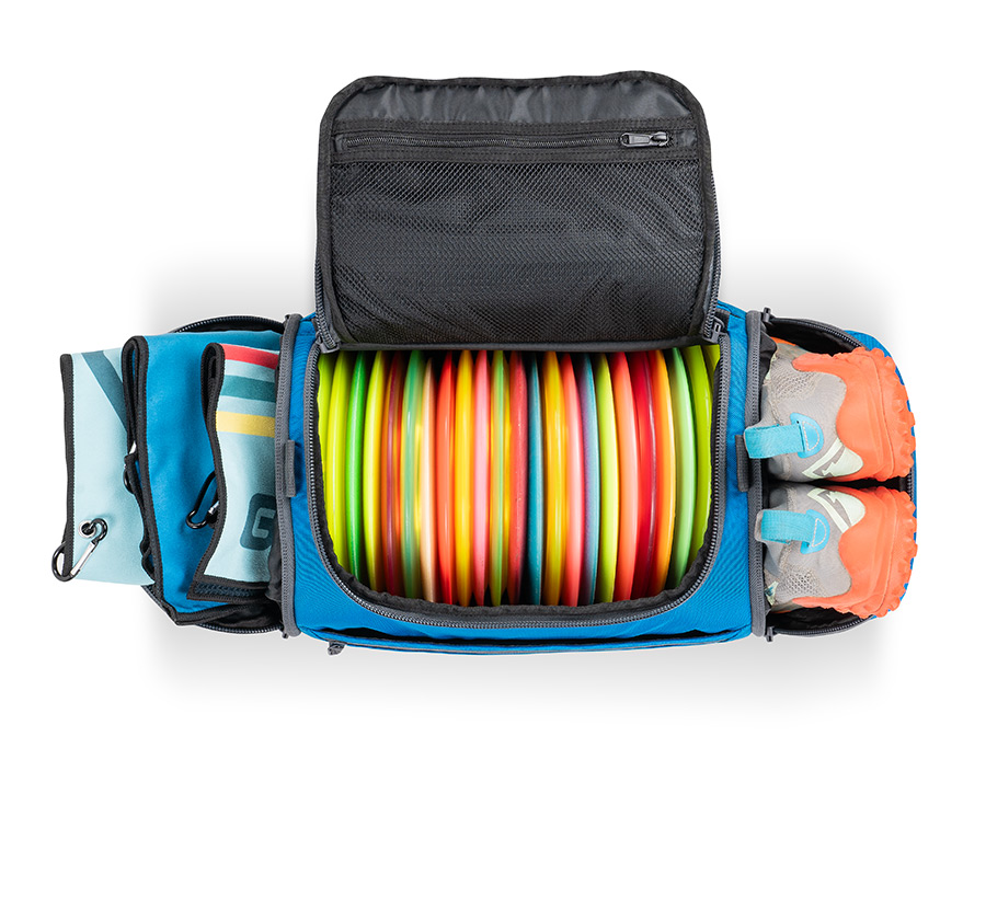 Blue disc golf duffel fully loaded with discs, shoes, and towels