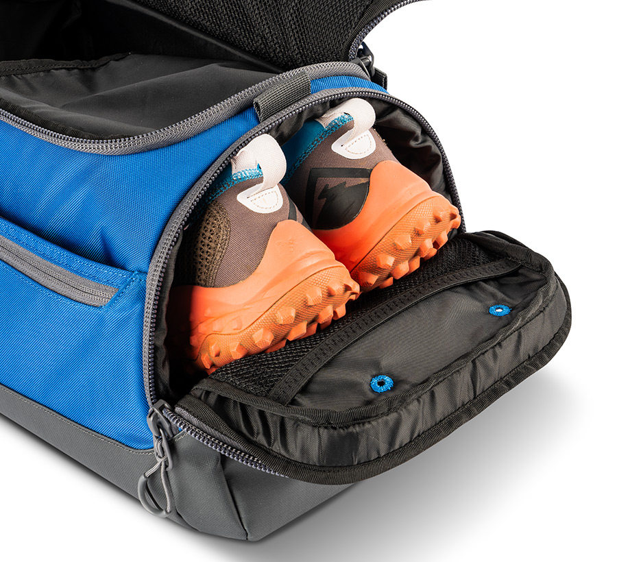 Blue disc golf duffel opened with shoes